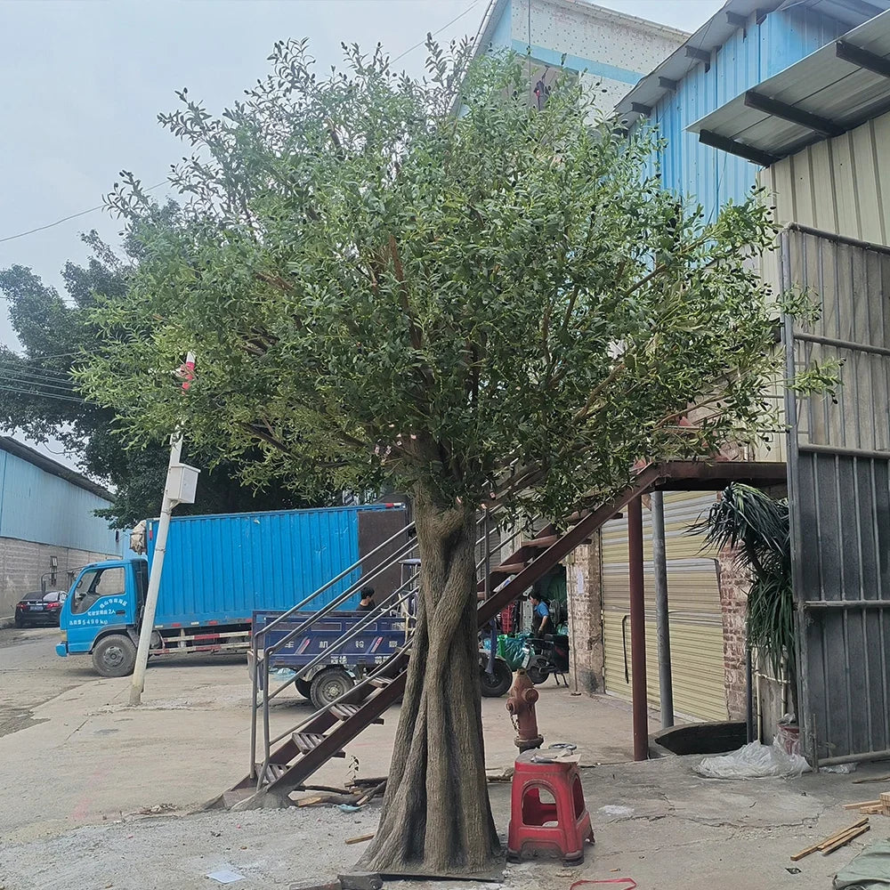 Large artificial olive tree with realistic silver-green foliage over a wide crown