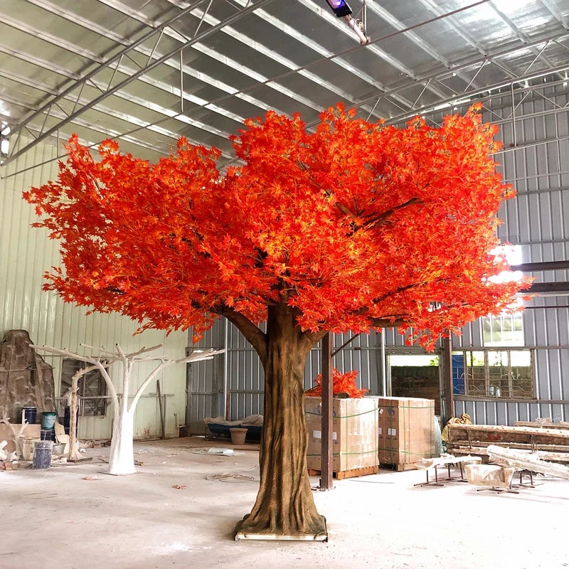 Artificial autumn canopy tree with red maple leaves spread across a wide crown