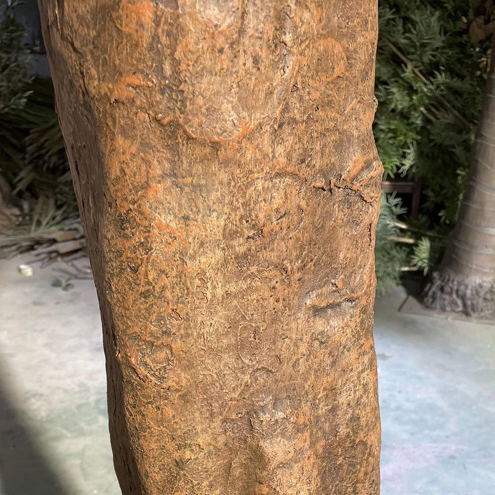 Base of the artificial acacia tree where the trunk meets its planter