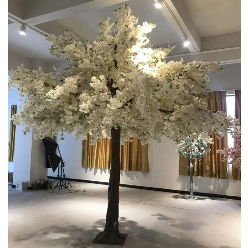 The 10ft blossom tree used as decor behind a dressed wedding ceremony aisle