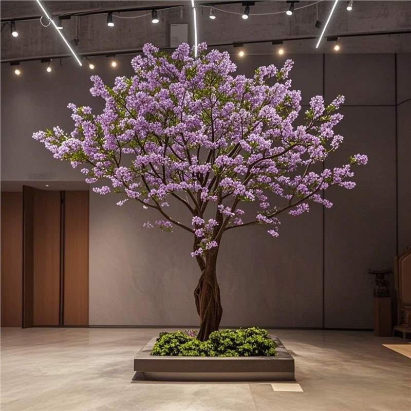 Artificial crabapple blossom tree covered in pale fabric flowers on bare branches
