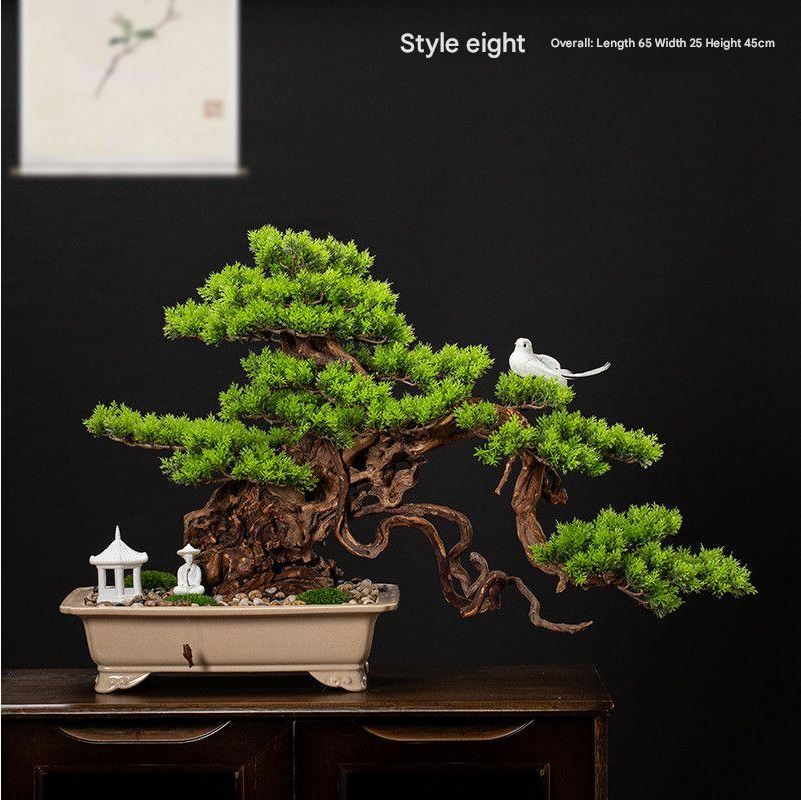 The lowest branch pad of the welcome pine reaching over the pot rim