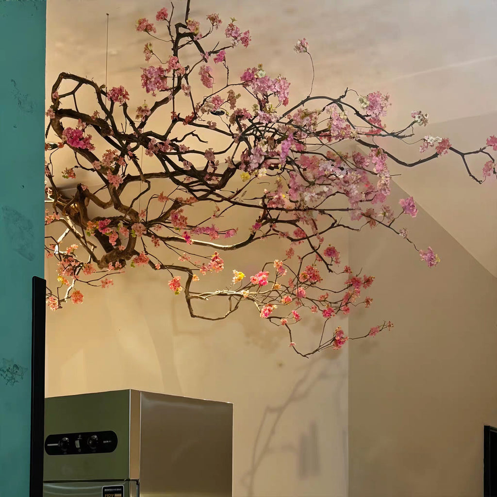 Close-up of the fabric flowers clustered thickly along the hanging branch