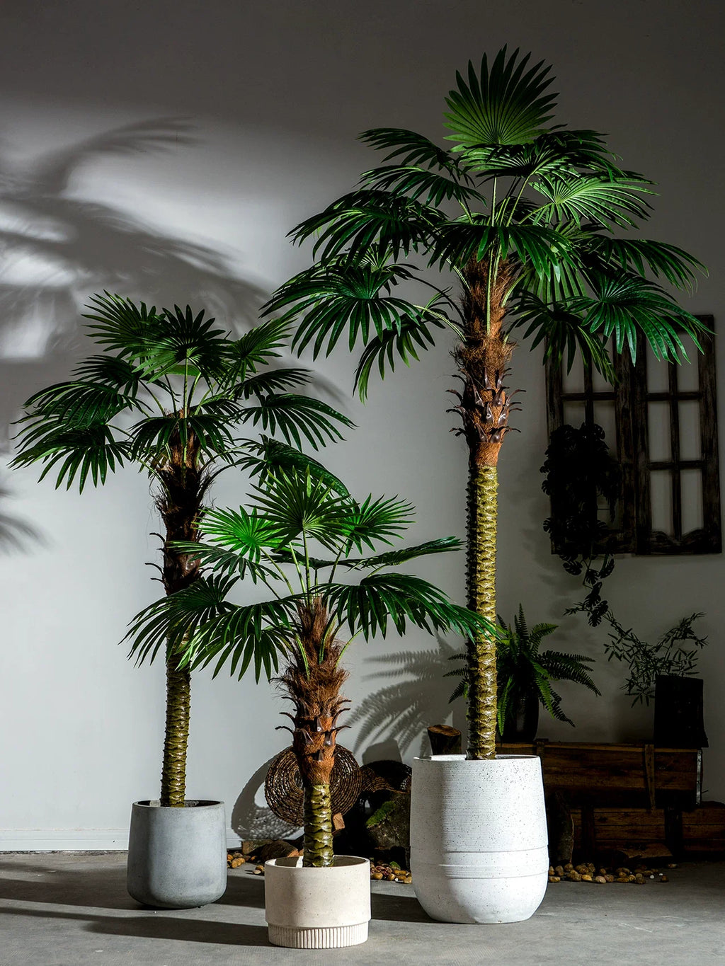Fan palms used as greenery framing either side of a styled event backdrop
