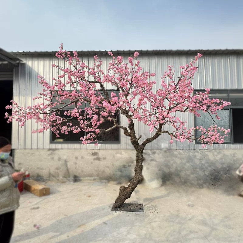 Tall faux cherry blossom tree with fabric flowers along slim minimalist branches