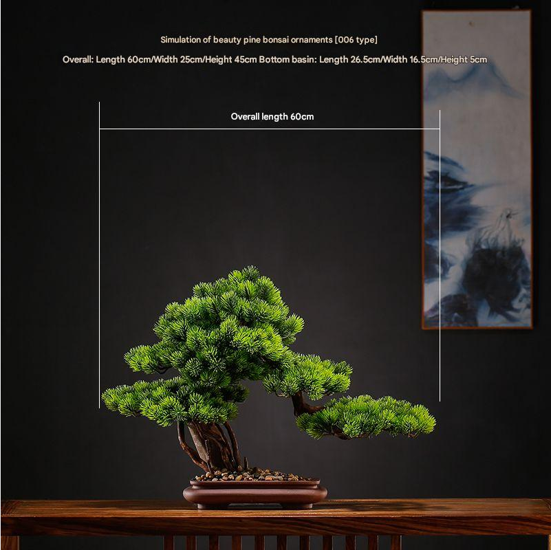 Two of the artificial pine bonsai displayed side by side on a table