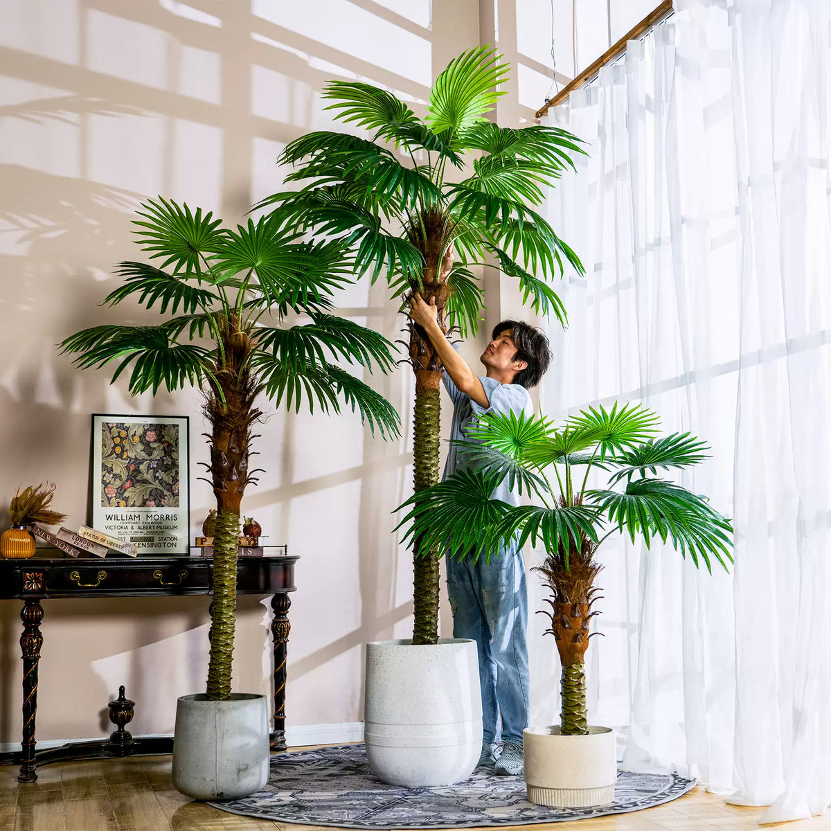 Artificial fan palm 6.6ft tall, pleated fan-shaped leaves rising from a slim trunk