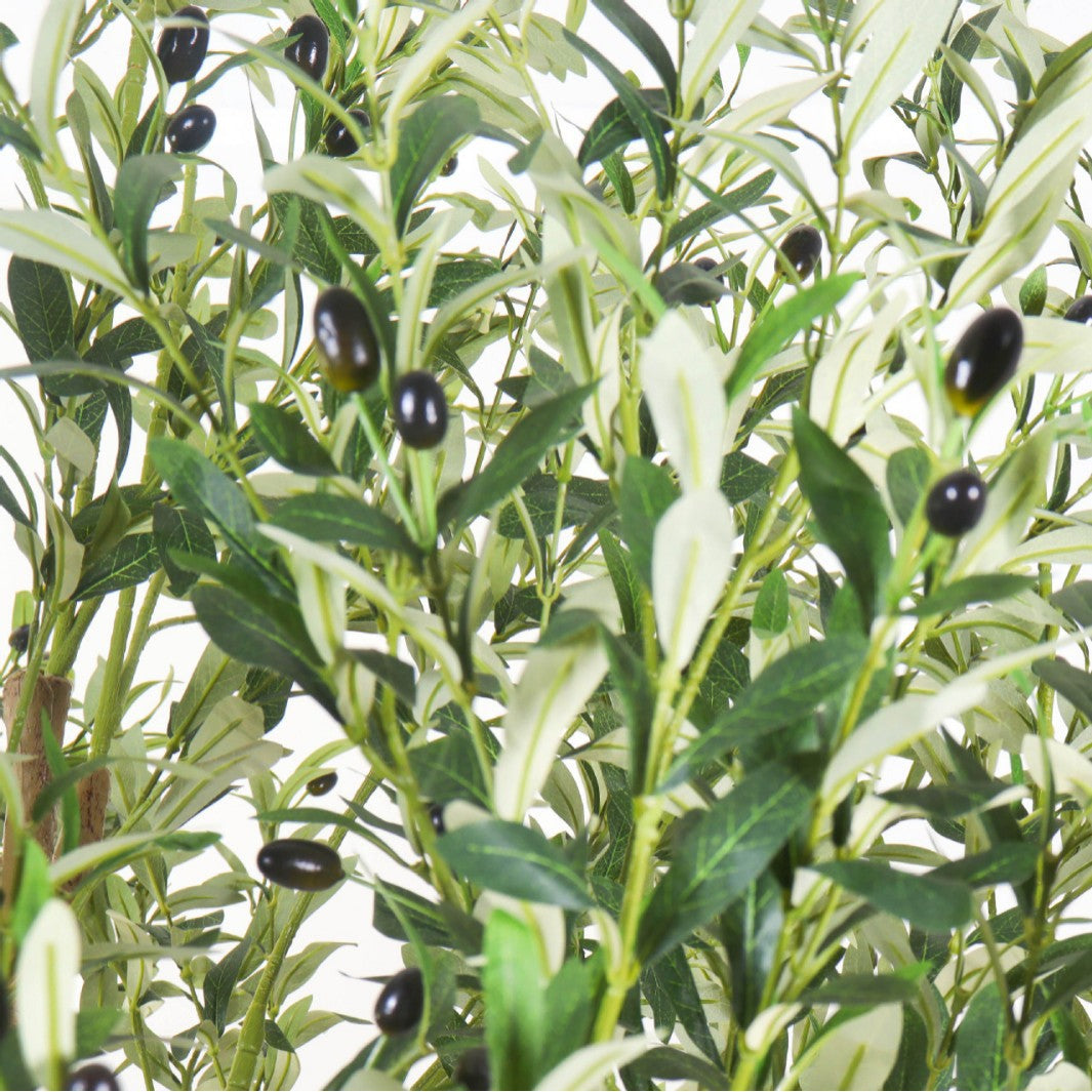 The trunk of the 3m artificial olive tree rising out of its large floor planter
