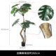 The plain pot and moss-topped base of the tall artificial monstera floor plant