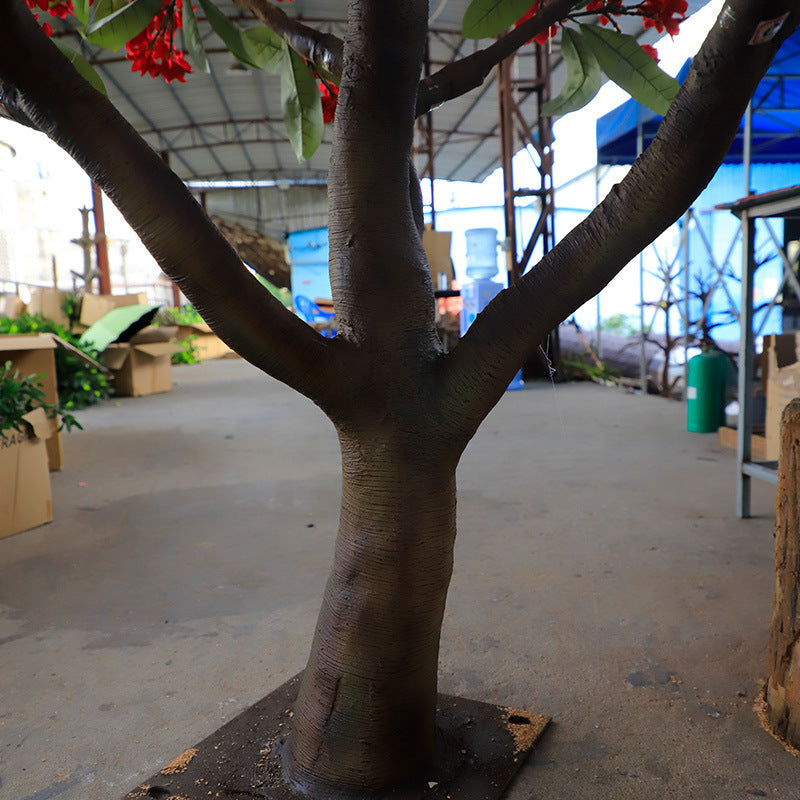 The plumeria tree used as a floor display beside a hotel lobby seating group