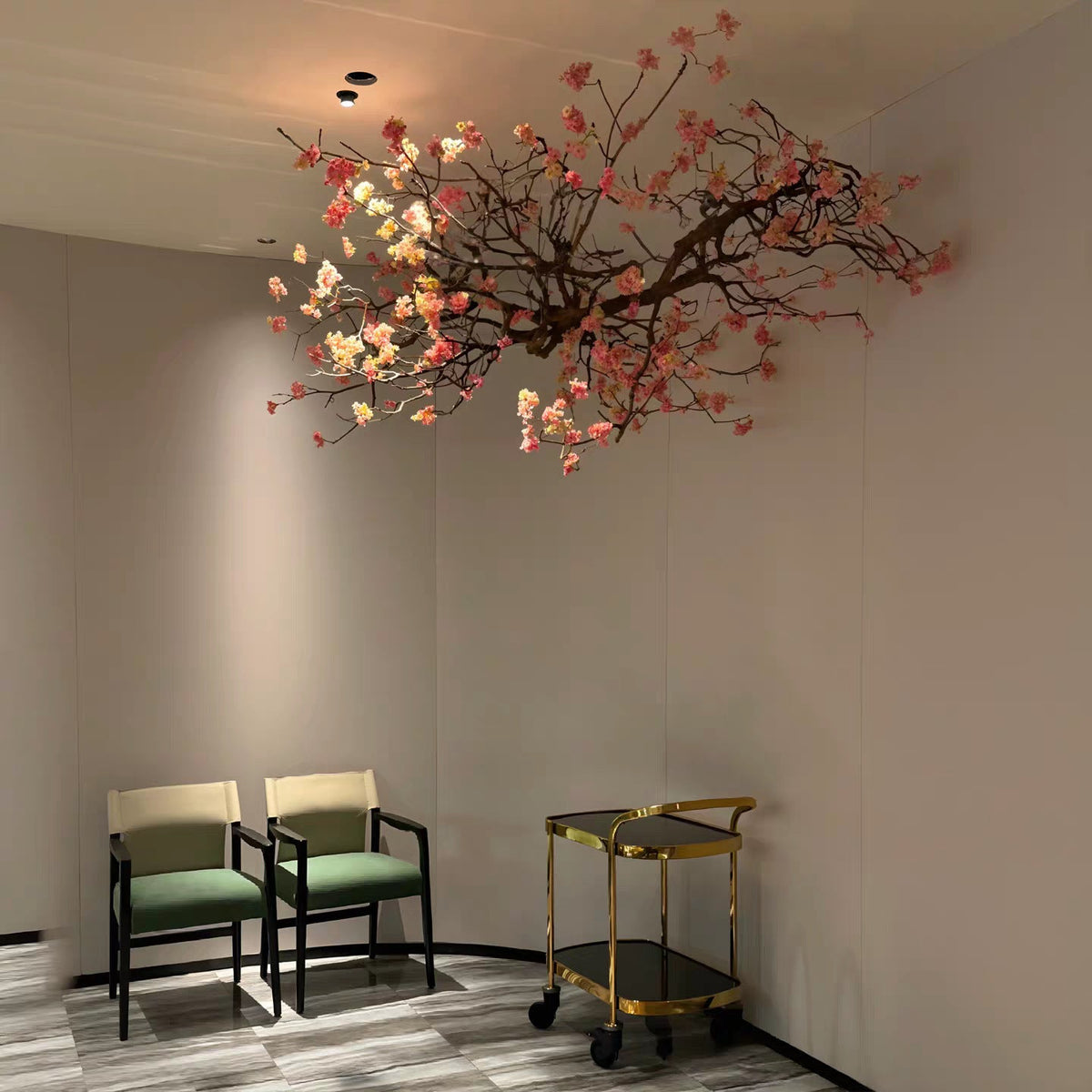 Several flower branches hung together to fill a ceiling above an event floor