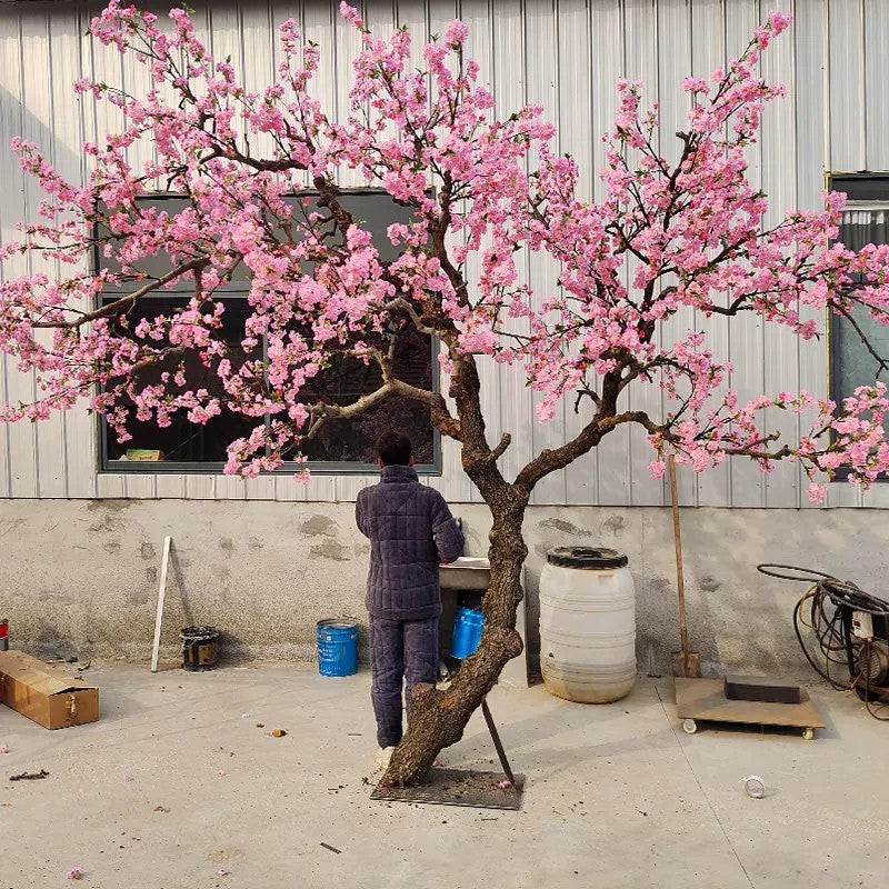 The cherry blossom tree in a hotel lobby, flowers reaching over the seating