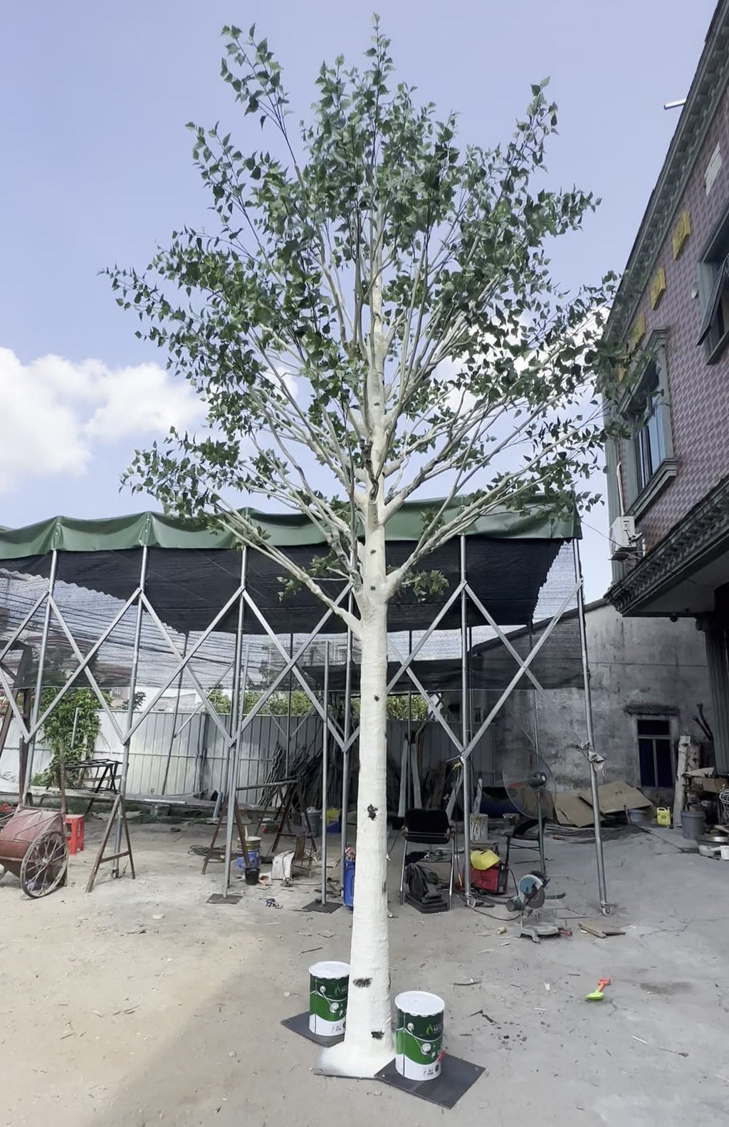 Base of the artificial birch where the trunk meets its floor planter