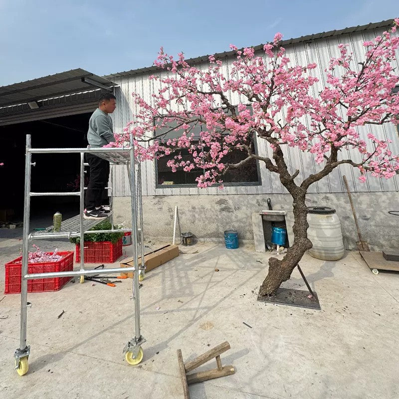 The faux blossom tree used as greenery in a shopping mall walkway display
