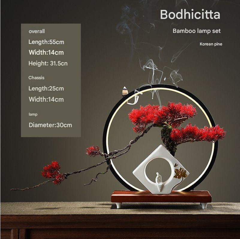The 24in bonsai in profile, its branches reaching out past the pot rim