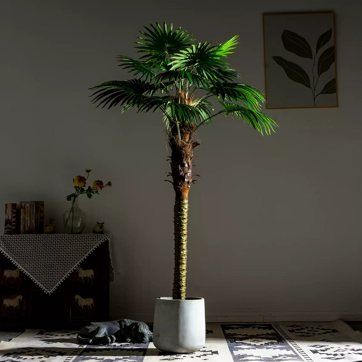 The slim trunk of the fan palm with its leaf stems fanning out from the crown