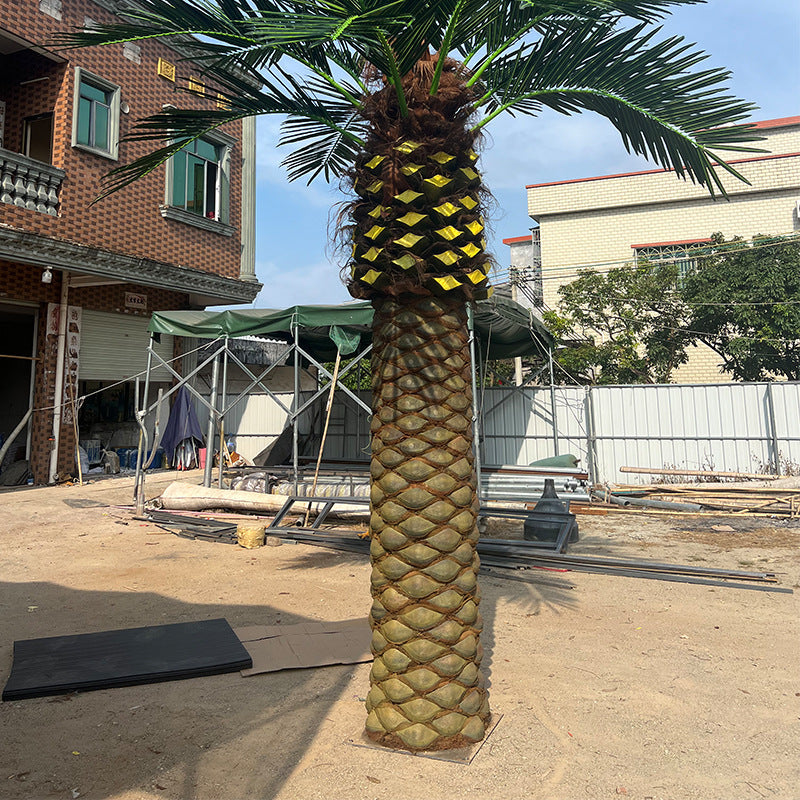 The 10ft date palm rising through an indoor atrium beside an upper walkway
