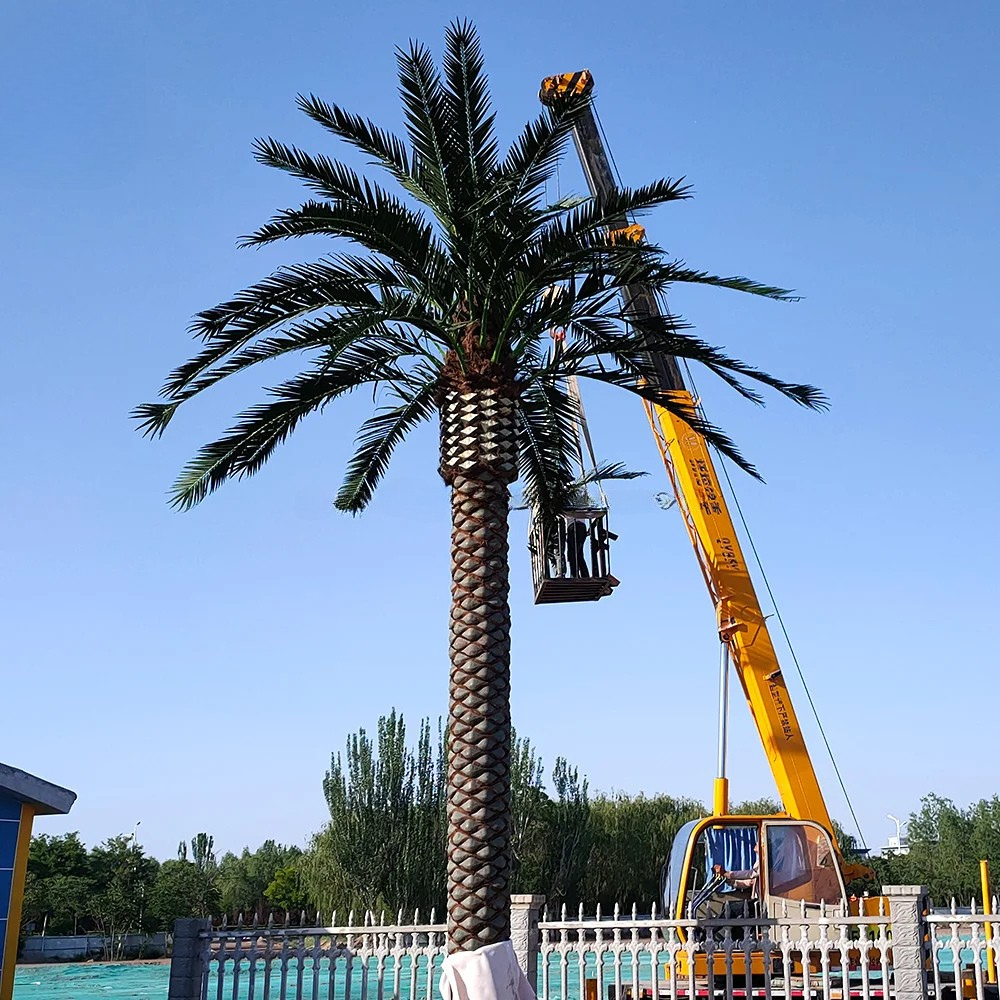 Artificial date palms of different heights planted along an outdoor walkway
