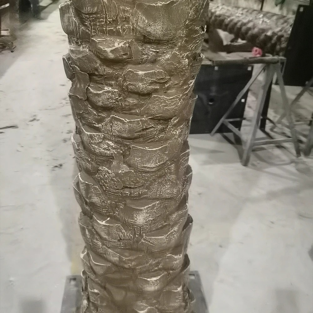 The patterned trunk of the Canary date palm with cut frond bases in rows