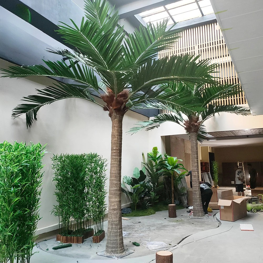 Large artificial coconut palm on a fibreglass trunk, fronds spreading at the crown