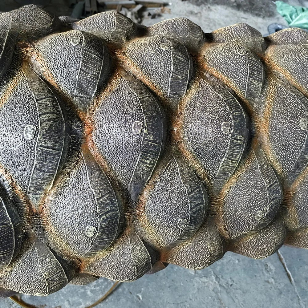 Base of the artificial date palm where the trunk meets the ground