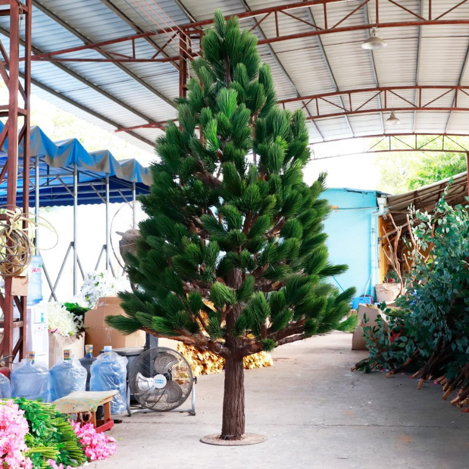 Artificial pine tree 8.5ft tall with dense evergreen needles across tiered branches