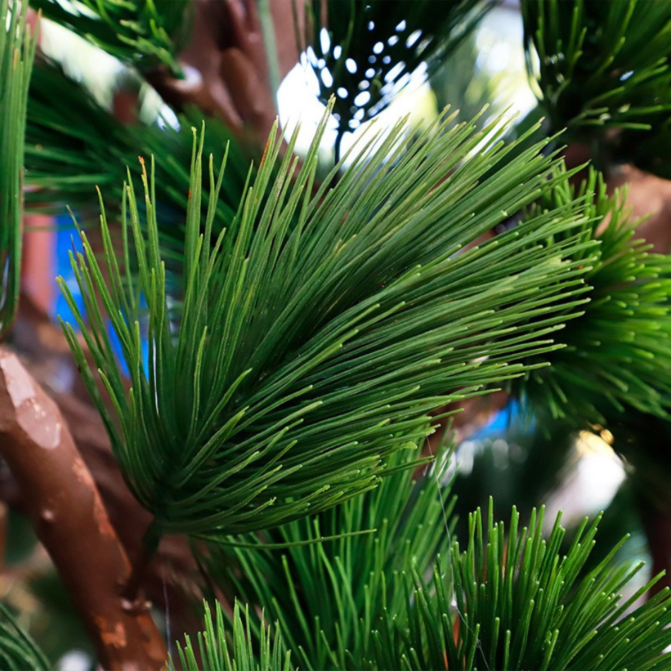 Close-up of the plastic pine needles fanning out densely along the branch tips