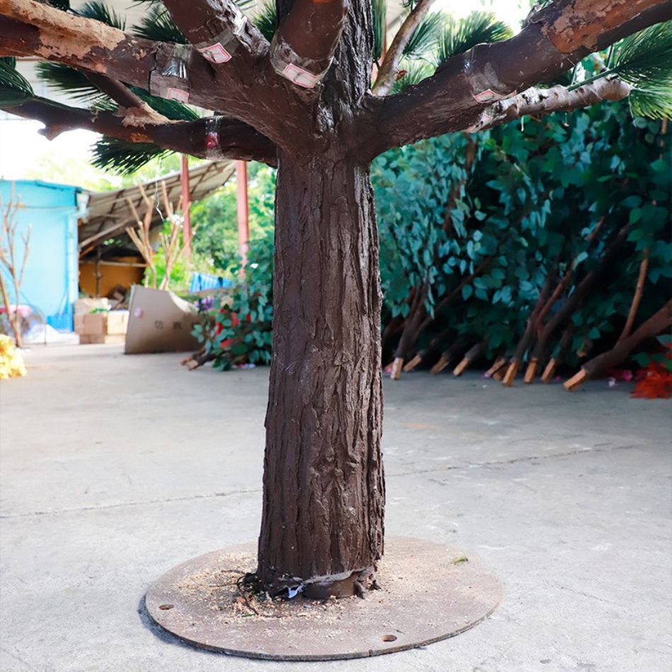 The 8.5ft artificial pine standing in a hotel lobby beside tall windows