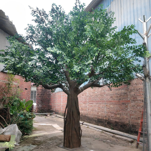 Artificial banyan ficus with dense green leaves across a wide spreading crown