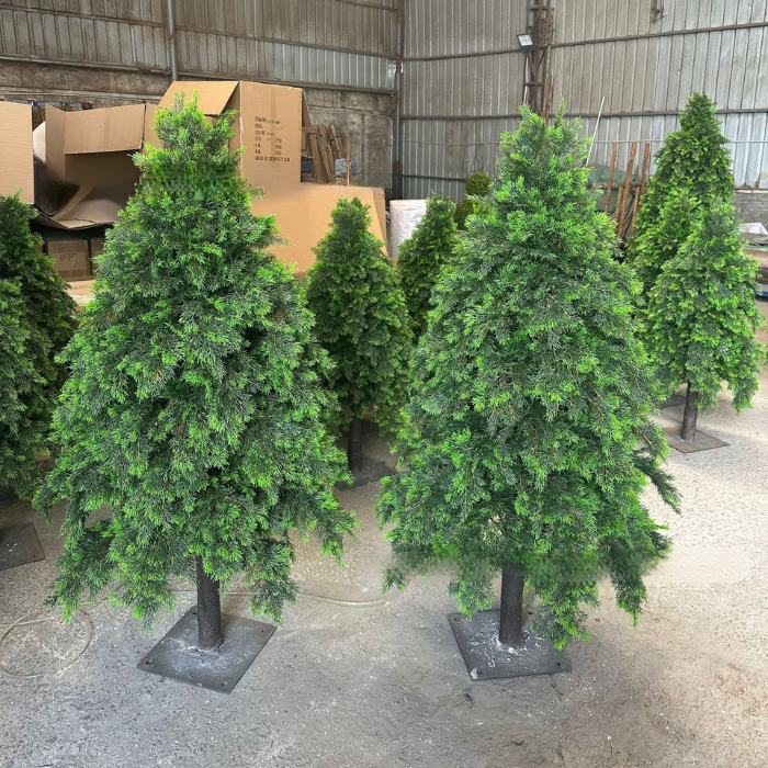 The cedar tree dressed with baubles and lights for an indoor holiday display
