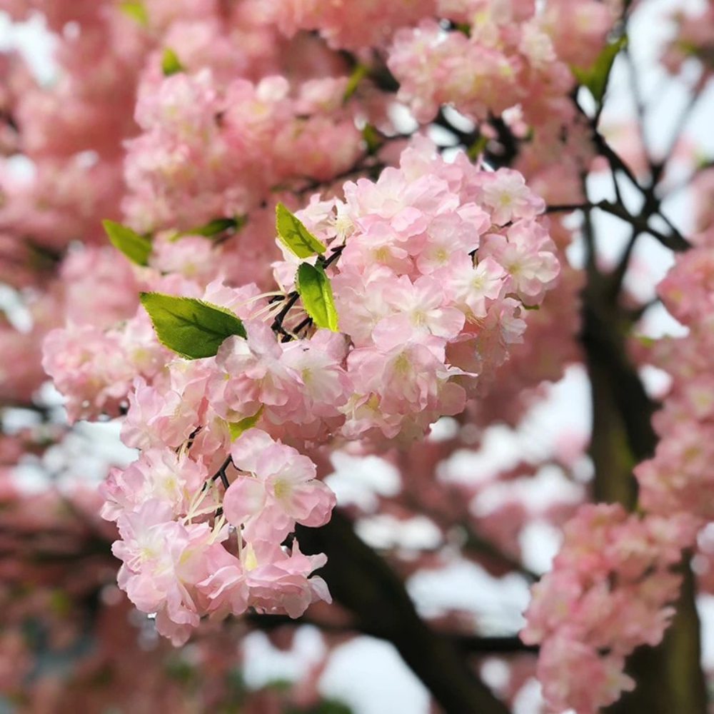 Close-up of the silk cherry blossoms showing their bright pink layered petals