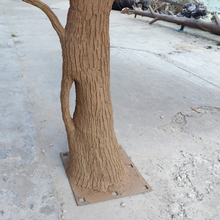 The natural wood trunk of the blossom tree with its bark grain visible
