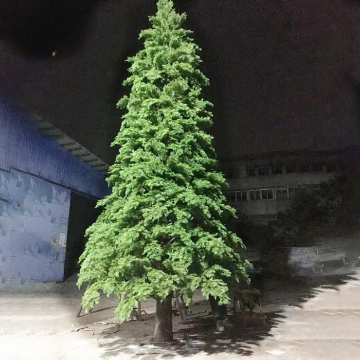 The lit 10ft Christmas tree glowing after dark in an outdoor display