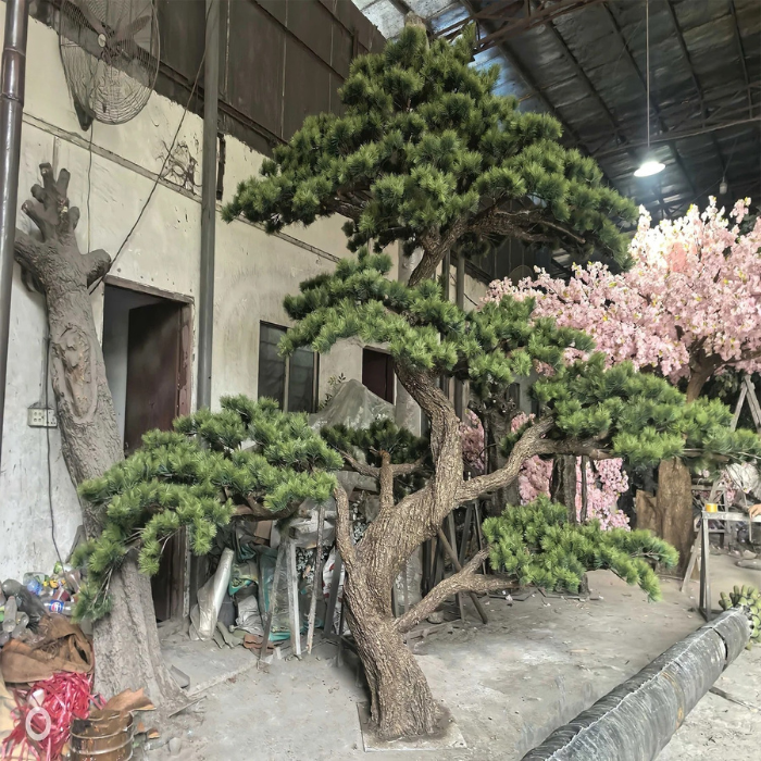 The sculpted bonsai trunk curving up from the base through the branches