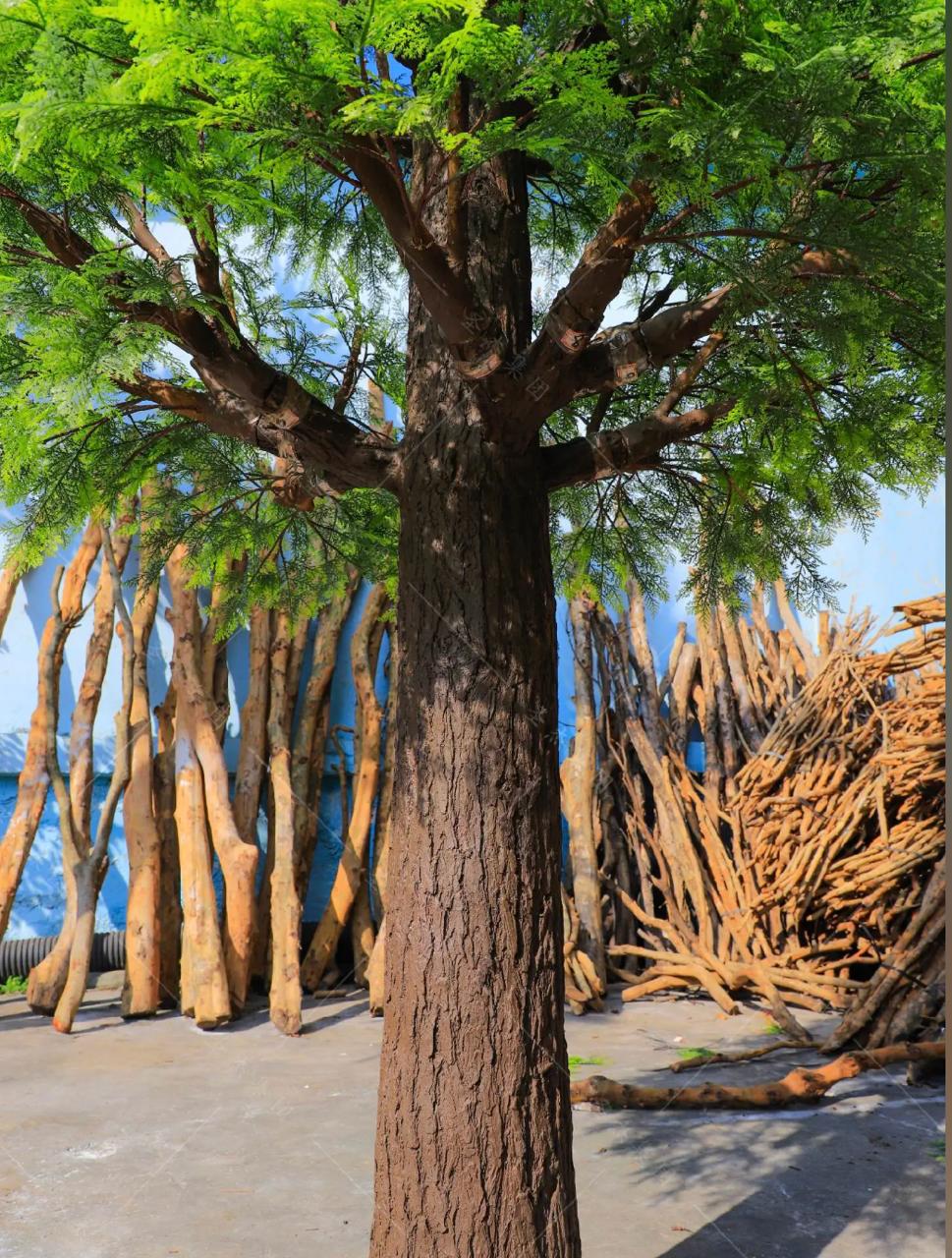 The trunk of the 14ft artificial pine rising between its tiers of branches