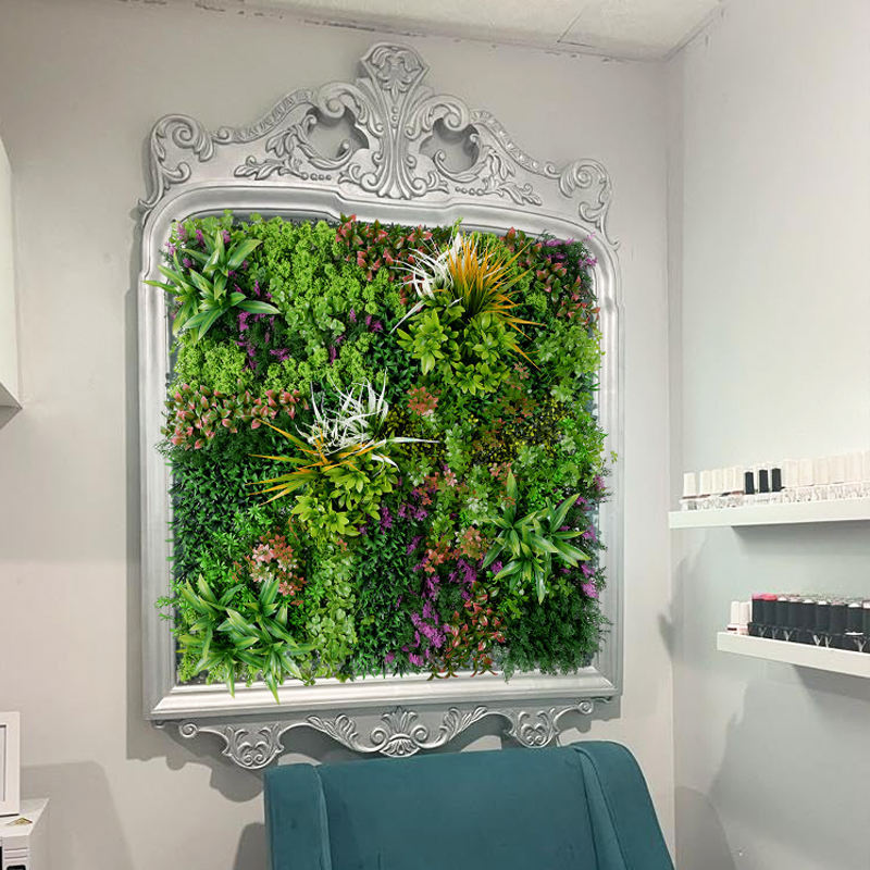 Grass wall hangings forming a green backdrop for a retail product display