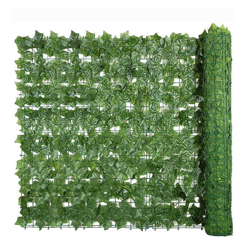 Faux ivy fencing running the full length of a patio boundary wall in a back garden