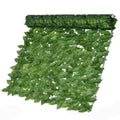 Artificial ivy leaf fence roll unrolled as a privacy screen, dense with green foliage