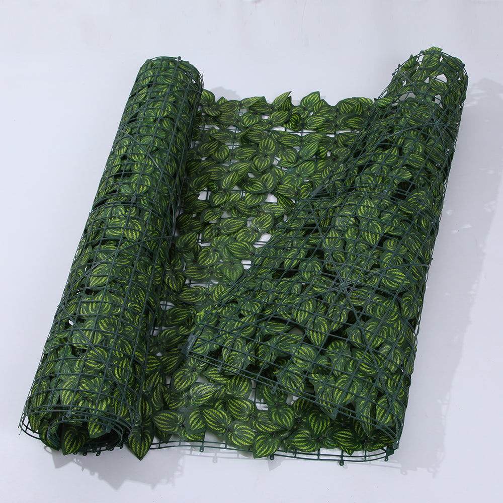 The washable ivy panel being rinsed under water to clear dust from the leaves