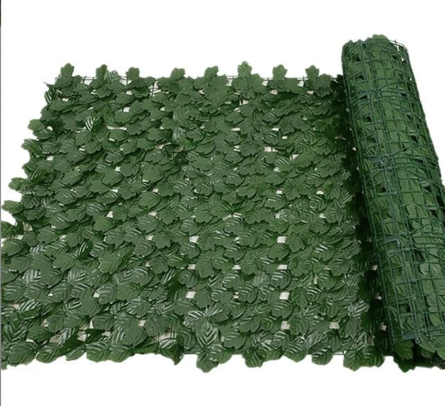 Artificial ivy wall panel hung as a privacy screen, dense with layered silk-look leaves