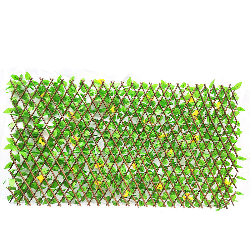 The faux ivy trellis screening a hotel terrace seating area from the street beyond