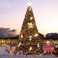 Commercial giant Christmas tree standing outdoors, lit through with LED tree lighting