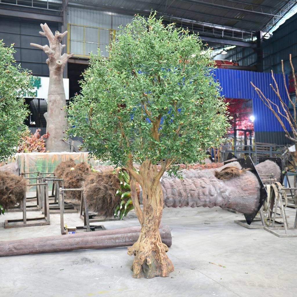 The artificial olive tree on a covered terrace beside outdoor dining tables