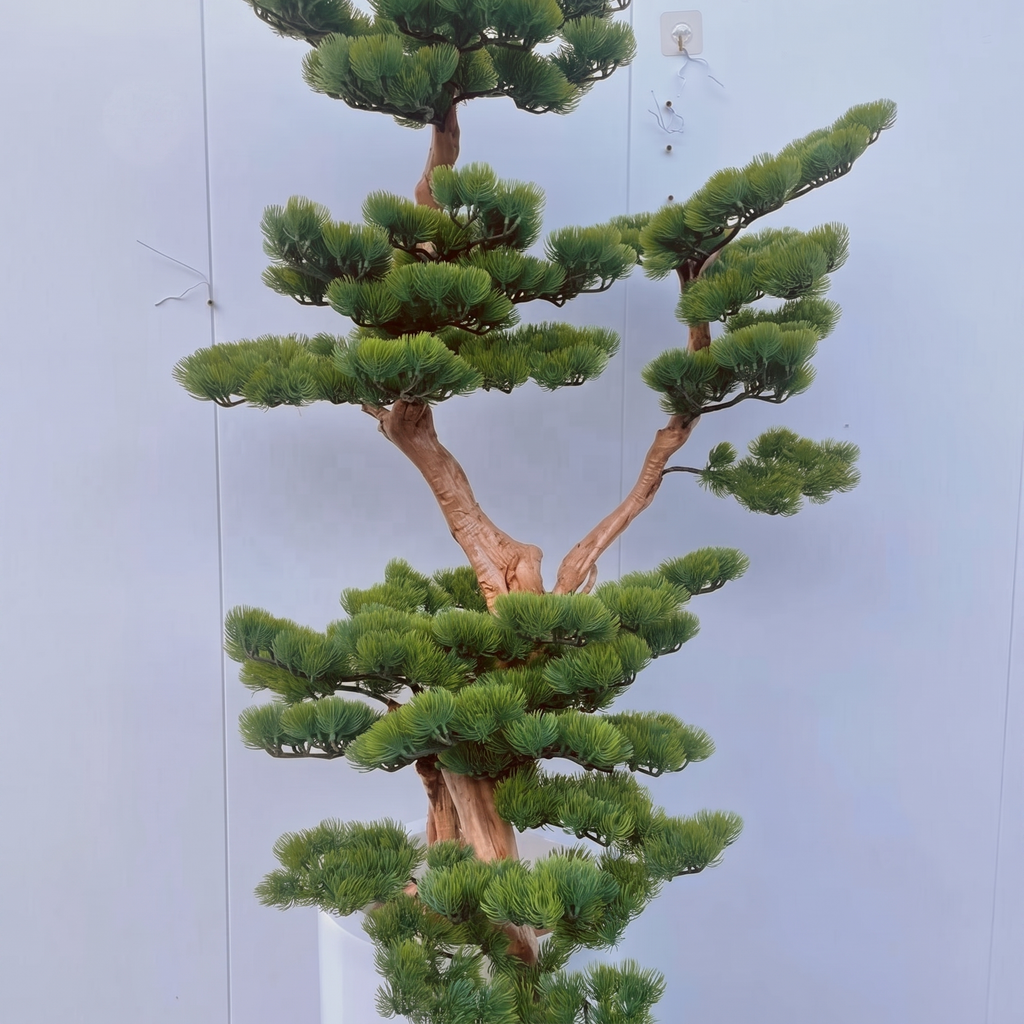 The 220cm faux pine bonsai standing in a hotel lobby beside a seating area