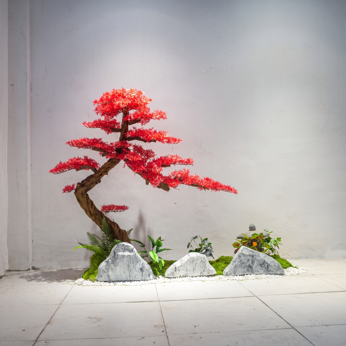 Faux maple foliage used in a retail window display against a plain backdrop