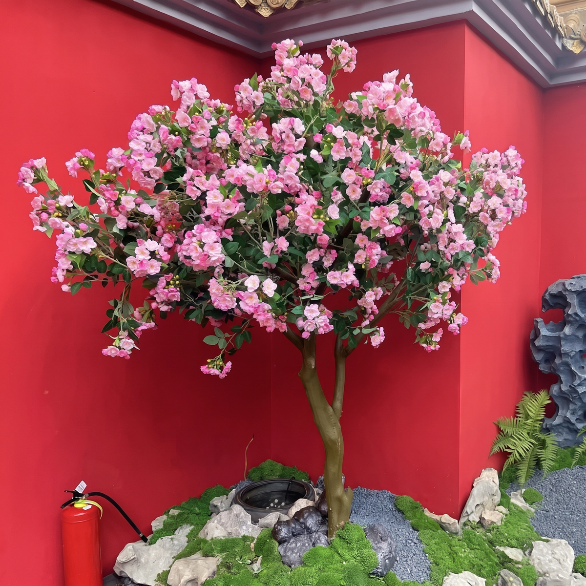 Artificial blossom tree massed with silk flowers on a rounded, flocked branch frame
