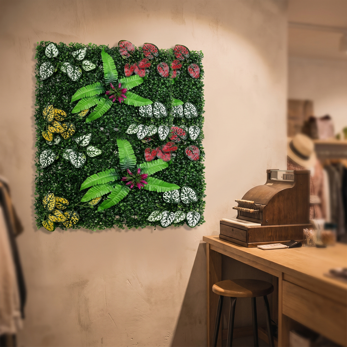 Artificial green wall hedge panels behind a boutique shop counter