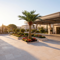 Large artificial palm tree at a hotel driveway entrance