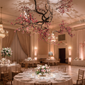 Faux flower tree ceiling hanging branch decor in an event space