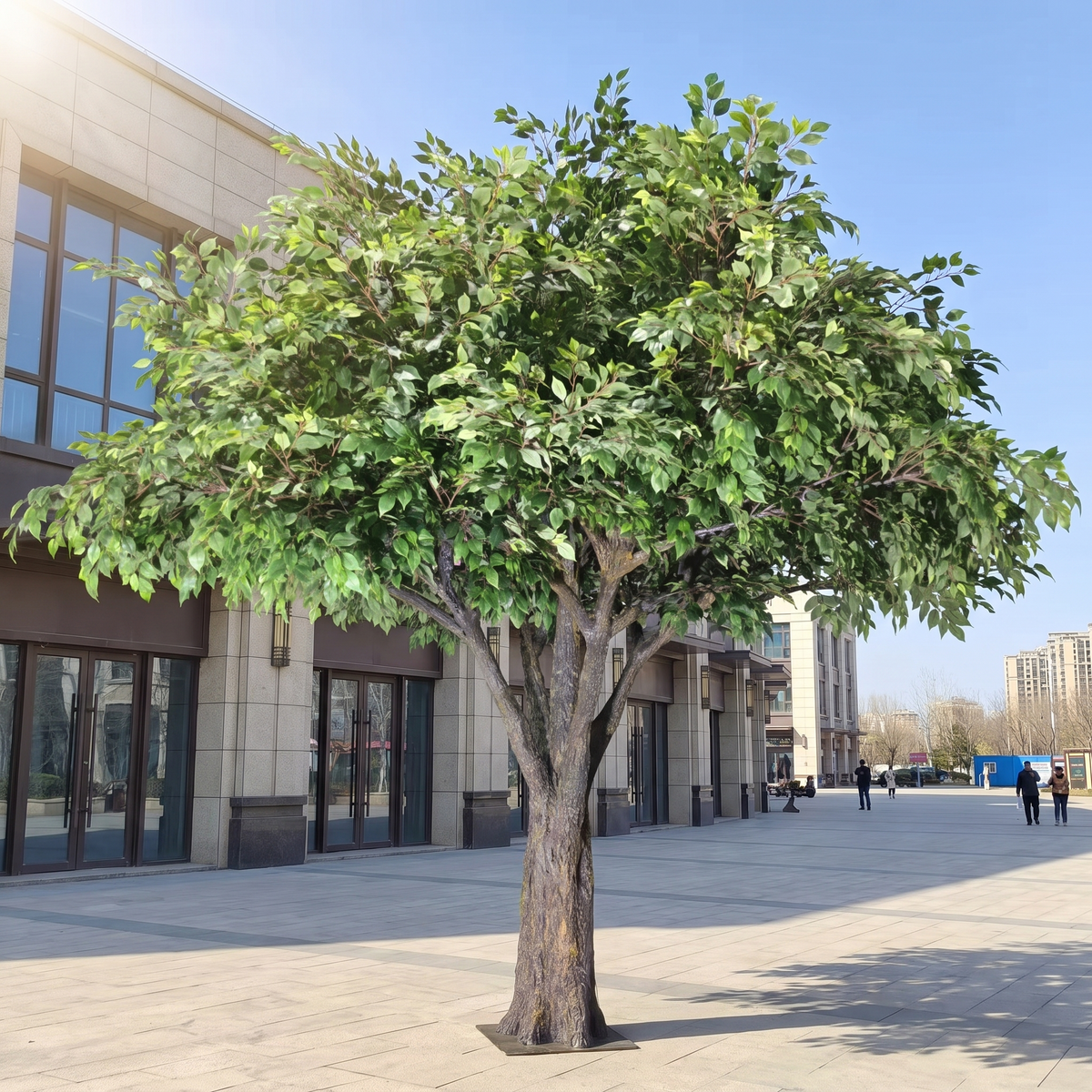 Large outdoor artificial ficus banyan tree on a public plaza